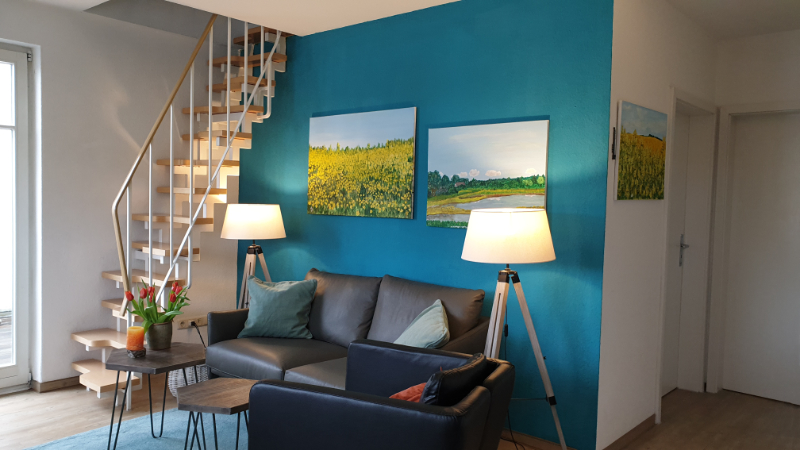 Wohnzimmer mit Treppe zu Schlafzimmer